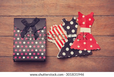Paper clothes on the wooden background