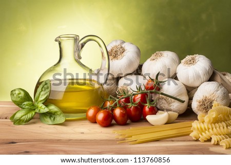 still life with olive oil,vegetables on wood table