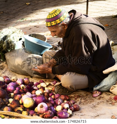 FES,MOROCCO - FEBRUARY 05:moroccan man selling vegetables and fruits in the souk of Fes on February 5,2013.Vegetables are important ingredients in the moroccan diet.