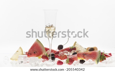 glass of wine with fruit on white background