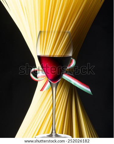 Spaghetti and glass of red wine with italian flag