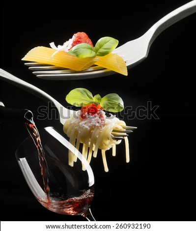 forks with macaroni spaghetti and tomato sauce on dark background