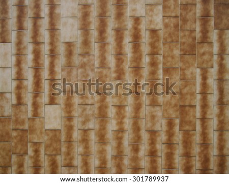 Brown rectangular tile cladding on exterior of a building of a department store built in the communist era of Czechoslovakia.