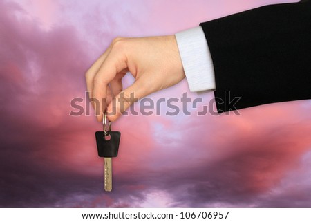 The Key to Success in the Hand on the dramatically Sky