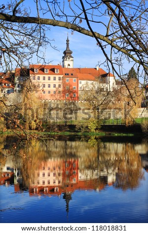 Colorful autumn medieval Town Pisek above the river Otava with the gothic deanery Church, Czech Republic