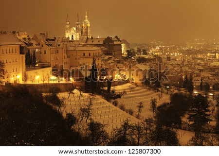 Romantic night snowy Prague City with gothic Castle, Czech republic