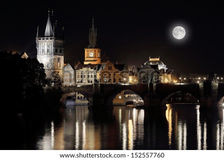 The night View on bright Prague Old Town with the Charles Bridge, its Bridge Tower and the National Theater with the Moon, Czech Republic
