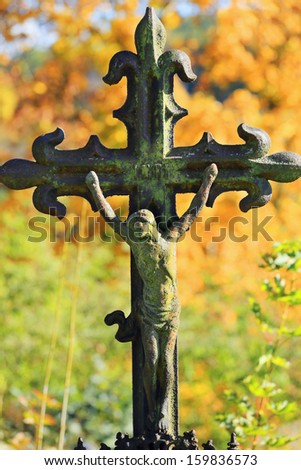 Jesus in colorful autumn Nature from the old village Cemetery, Czech Republic