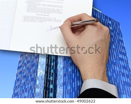 The Signature of Business Contract in front the Skyscraper on the blue Sky