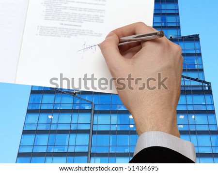 The Signature of Business Contract in front of the Skyscraper