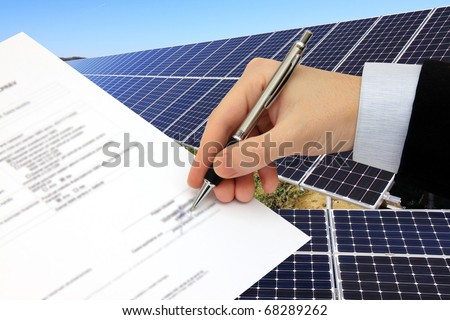 The Signature of Business Contract in front of the Solar Power Station in the green Nature
