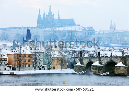 Freezy foggy snowy evening  Prague with gothic Castle and Charles Bridge