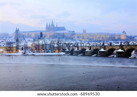 Freezy foggy snowy evening  Prague with gothic Castle and Charles Bridge