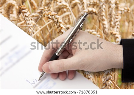 The Signature of Business Contract in front of the Cornfield