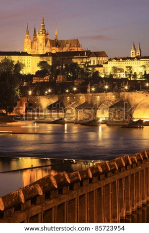 Colorful Prague gothic Castle above the River Vltava with Charles Bridge in the Night