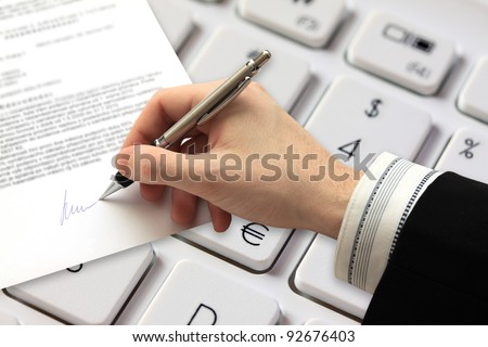 The Signature of Business Contract in front of Computer