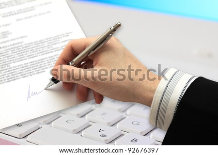 The Signature of Business Contract in front of Computer
