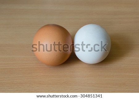 Duck egg and Chicken egg on the wooden table