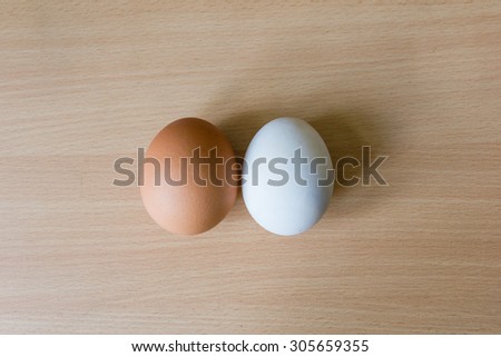 Duck egg and Chicken egg on the wooden table