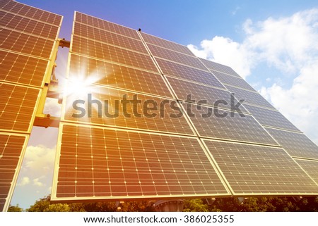 Low angle view of solar photovoltaic cell panels in bright sunlight.