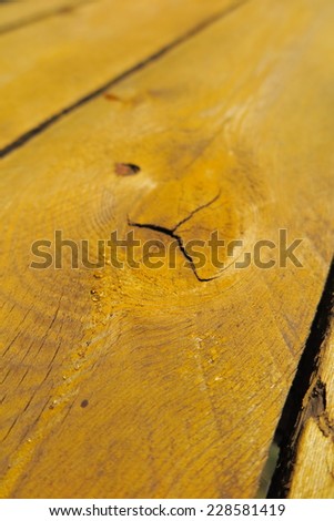 Old weathered pine boards being yellow painted