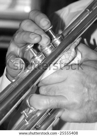 Man\'s hands playing a trumpet