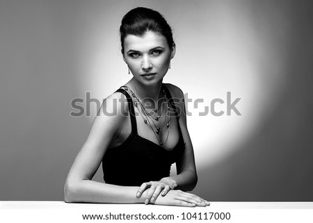 Black and white portrait  of luxury woman in exclusive jewelry on natural background