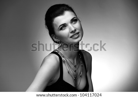 Black and white portrait  of luxury woman in exclusive jewelry on natural background