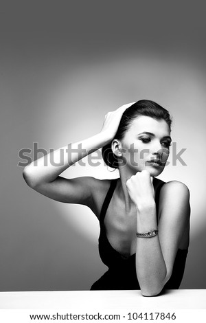 Black and white portrait of luxury woman in exclusive jewelry on natural background