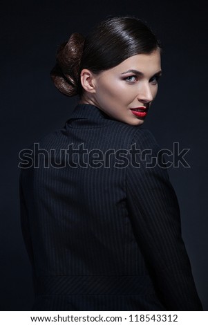 Portrait of sexy business woman in a suit. Professional makeup and hairstyle