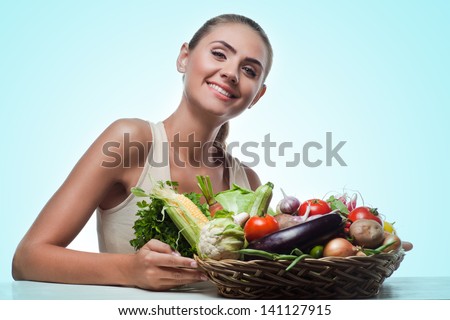 Close-up portrait of happy young woman with  bundle herbs (salad) in hands.  Concept vegetarian dieting - healthy food