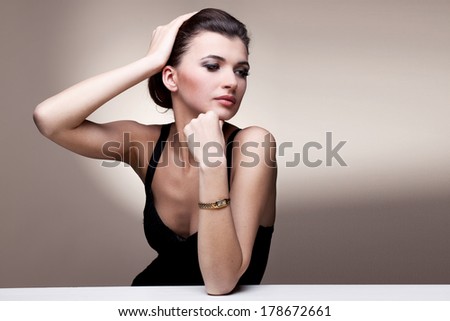 Portrait of luxury woman in exclusive jewelry watch on natural background