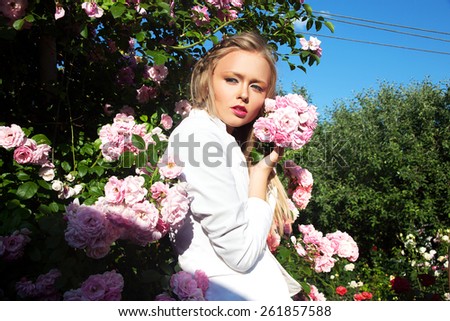Beauty woman with bunch rose flowers. Professional Makeup and hairstyle