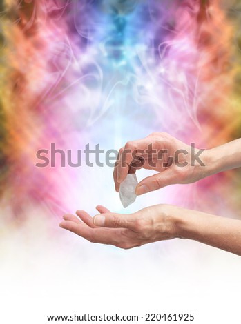 Crystal Healer holding terminated quartz in one hand pointing at open palm with psychedelic rainbow colored energy formation in background