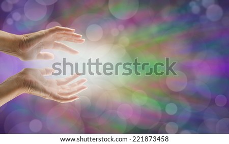 Female hands reaching out with white light and bokeh effect background