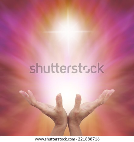 Female healing hands outstretched with bright shaft of light and cross above on a golden magenta energy background