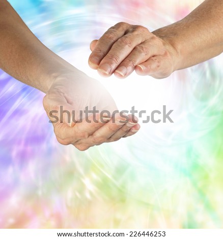 Sensing energy vortex  -  Healer sensing energy between cupped hands with a swirling colorful vortex of energy in background