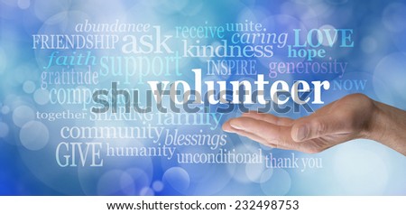 Volunteers needed hand gesture on blue bokeh  -  Male hand palm up with the word \'volunteer\' floating above surrounded by relevant words on a blue bokeh background