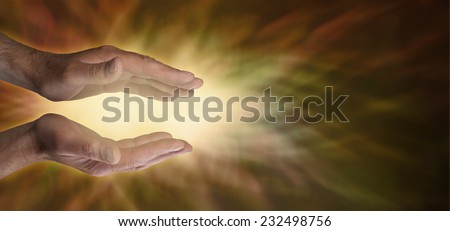 Beautiful Golden Healing Energy Field - male healer with hands cupped parallel on a golden brown energy background and yellow gold light between palms