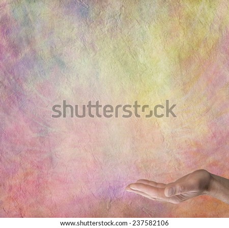 Spiritual Rainbow Message Board Background  -  Male hand outstretched with palm facing up on a multicolored stone effect  background with plenty of copy space