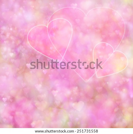 Three pink heart outlines on a soft pink bokeh heart background