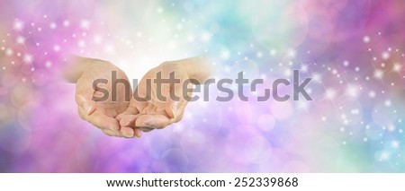 Ask Believe Receive  -  Pair of cupped palm up female hands on left side emerging from delicate bokeh sparkling background with pale pastel coloring