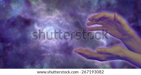 Cosmic Healer - wide night sky showing a nebula in outer space background with a women\'s hands in the foreground in a sensing energy position with pale lilac aura and plenty of copy space