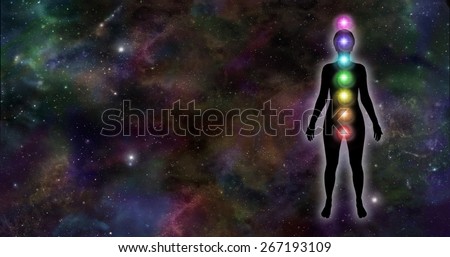 Universal Chakra Silhouette  -  Female silhouette with seven healing chakras on dark deep space night sky background with plenty of copy space on left hand side