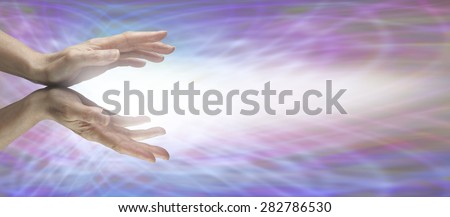 Beaming Reiki Energy - Healer\'s outstretched hands with energy beaming outwards on a purple matrix background