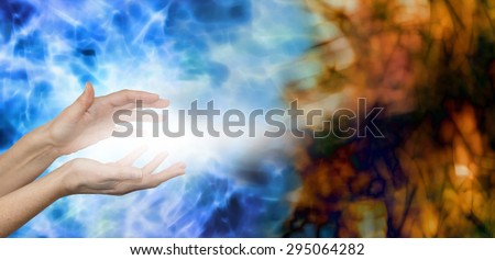 Dispersing Negative Energies -  Female hands on water blue background with stream of white energy between hands appearing to disperse mucky brown energy field on right hand side