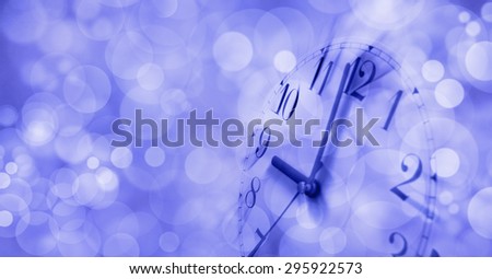 Wake up sleepy head -  Motion blur clock face showing 9 o\'clock on a dreamy blue bokeh background with plenty of copy space on left hand side