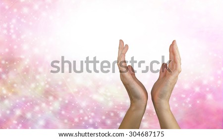 Sending Healing Energy - Female healing hands reaching up from a pink sparkling energy background