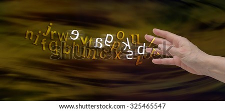 Understanding Dyslexia Website Banner -  female hand with the alphabet flowing from fingers in gold with six letters flipped in white to symbolize dyslexia