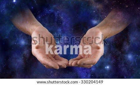 Cosmic Karma is in Your Hands  - Male hands emerging from a deep space night sky dark blue  background, cupped cradling the word KARMA